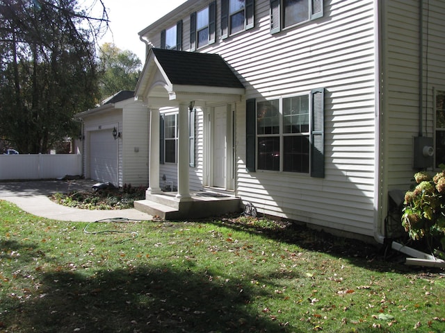 property entrance with a yard and a garage