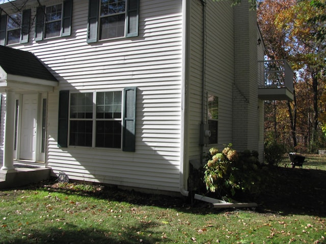 view of side of property with a yard