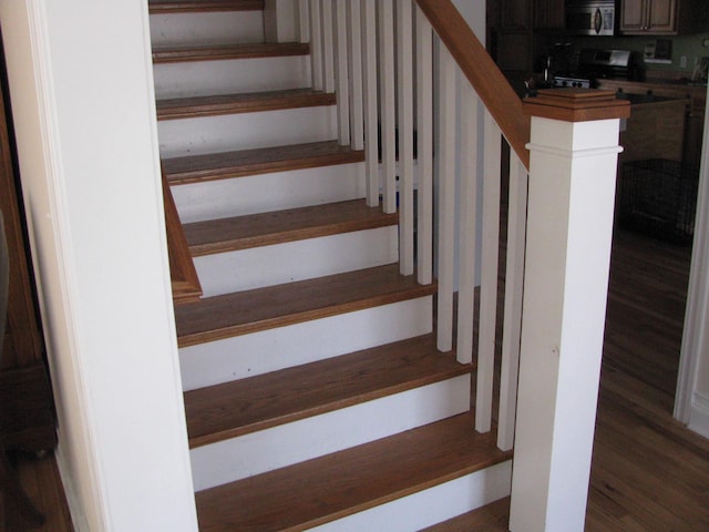 stairs with hardwood / wood-style floors