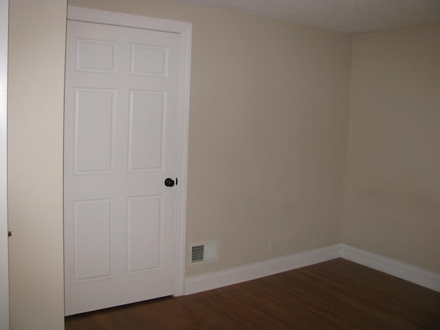 empty room with dark hardwood / wood-style floors