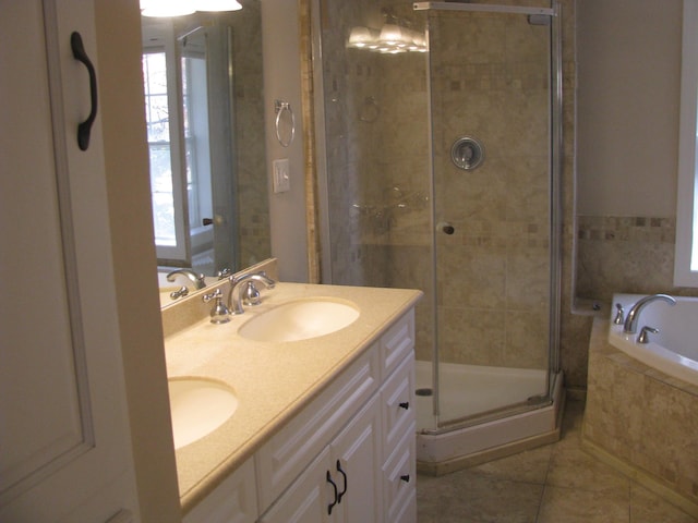 bathroom featuring tile patterned flooring, vanity, a wealth of natural light, and independent shower and bath