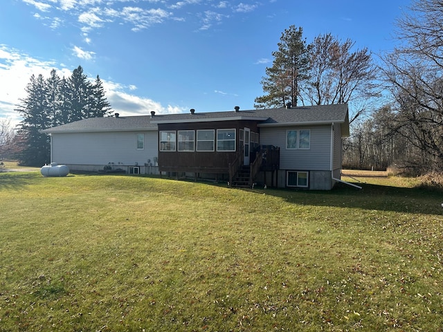 rear view of property with a lawn