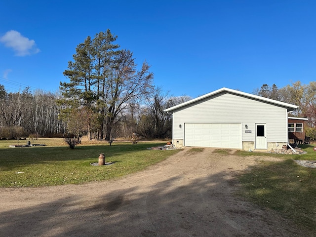 view of property exterior with a garage and a yard