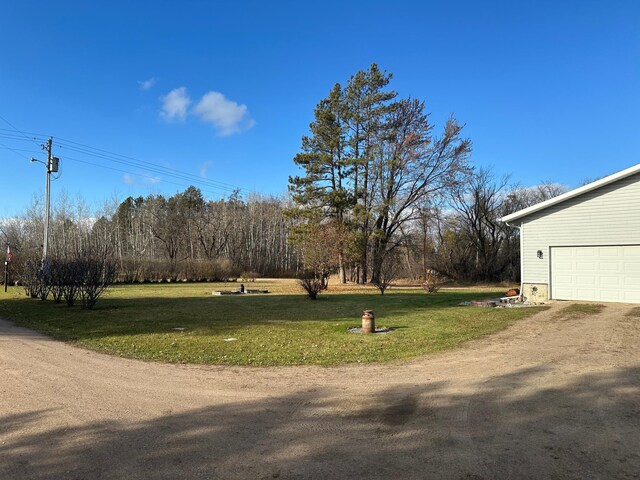 30468 600th Ave, Moranville Twp, MN 56763 - view of grassy yard featuring a garage and driveway