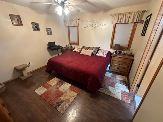 bedroom with dark hardwood / wood-style flooring and ceiling fan