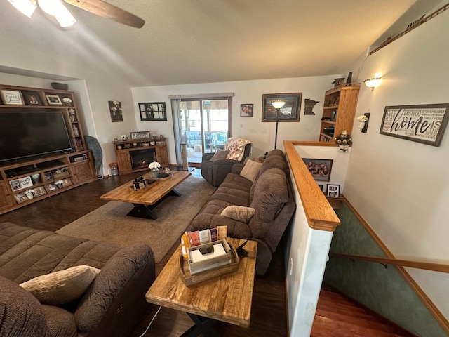 living room featuring lofted ceiling, ceiling fan, and dark hardwood / wood-style flooring