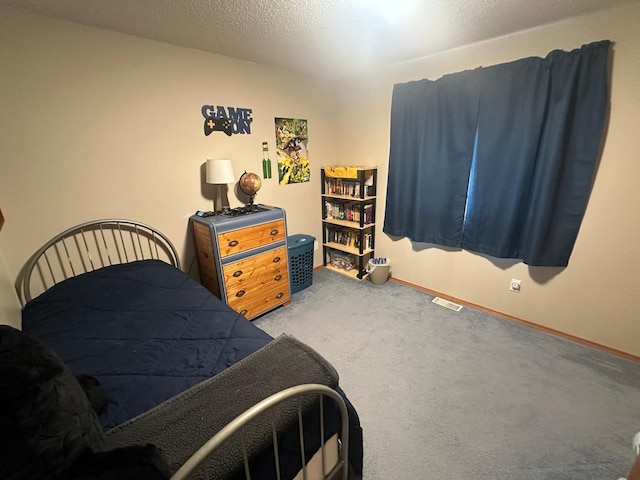 bedroom with carpet flooring and a textured ceiling