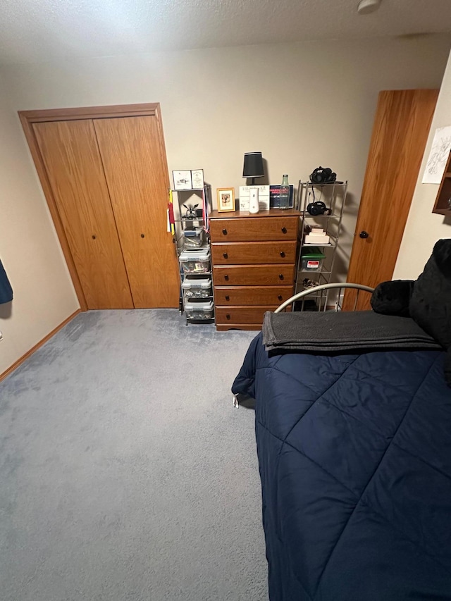 bedroom with light colored carpet and a closet