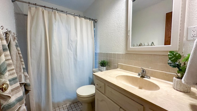 bathroom featuring toilet, a shower with curtain, vanity, and tile patterned floors