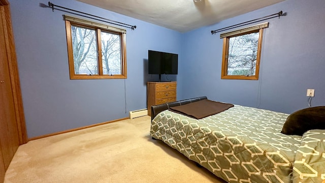 carpeted bedroom with a baseboard heating unit