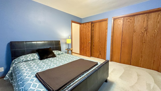 carpeted bedroom with multiple closets