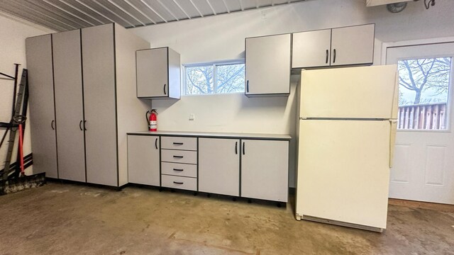 kitchen with gray cabinetry and white refrigerator