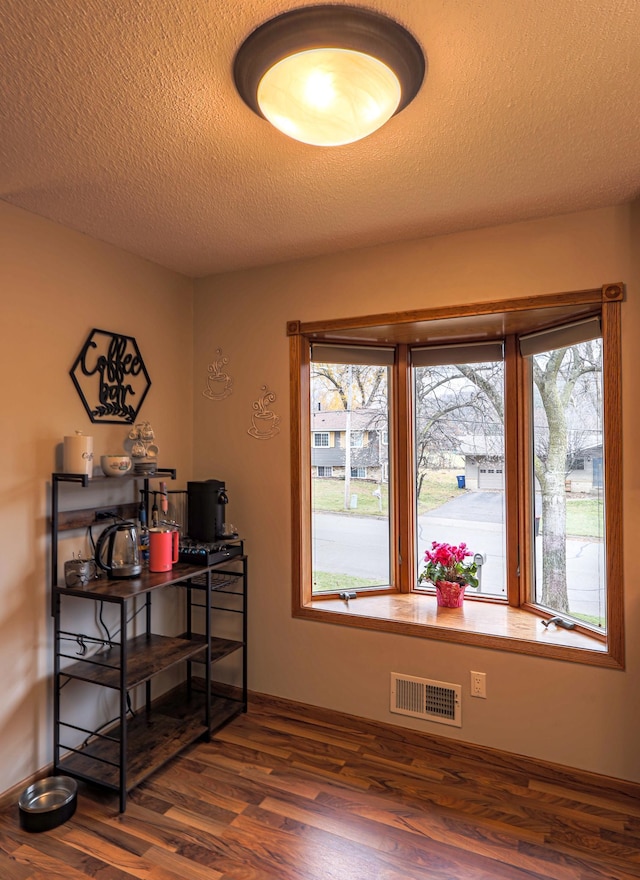 interior space with dark hardwood / wood-style floors and a textured ceiling