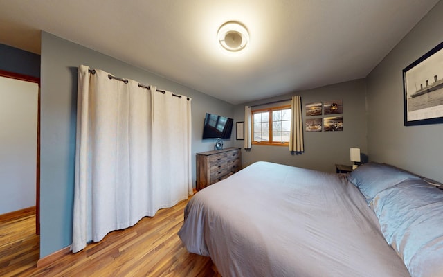 bedroom with hardwood / wood-style floors