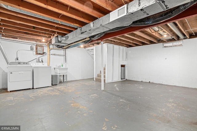 basement featuring sink and washer and dryer