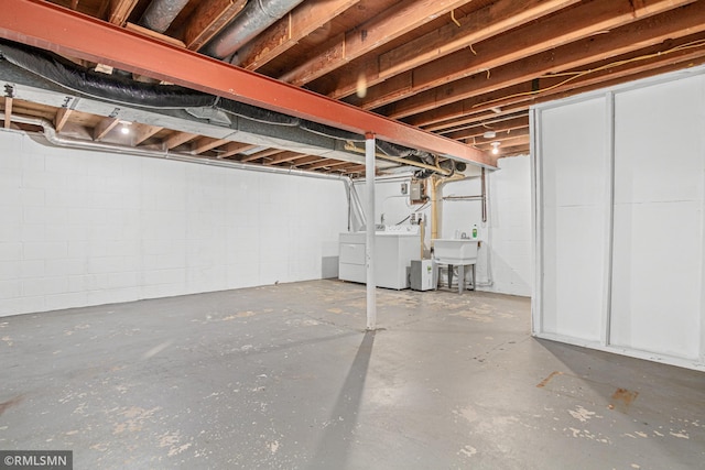 basement featuring sink and washer and dryer