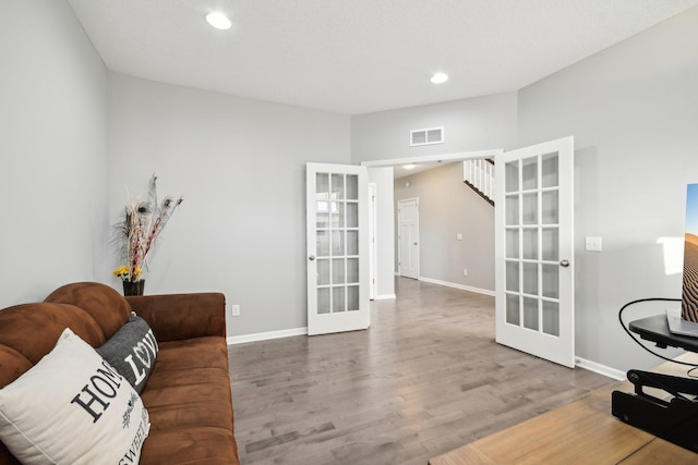 interior space with hardwood / wood-style floors and french doors