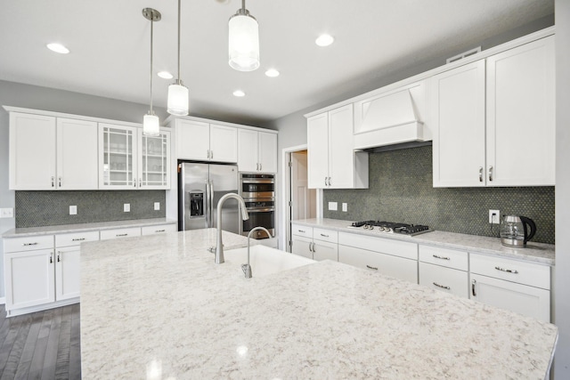 kitchen with pendant lighting, white cabinets, dark hardwood / wood-style floors, and stainless steel appliances