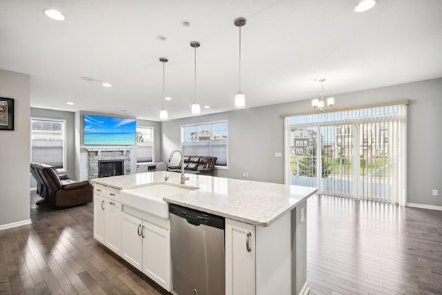 kitchen featuring dark hardwood / wood-style flooring, white cabinetry, stainless steel dishwasher, and hanging light fixtures