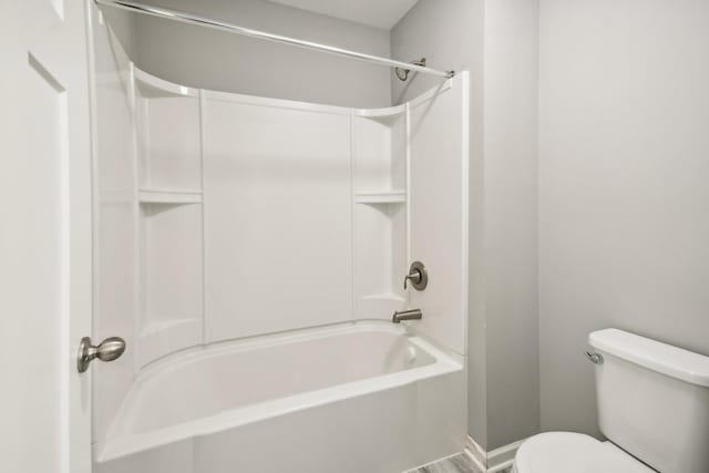 bathroom with washtub / shower combination and toilet