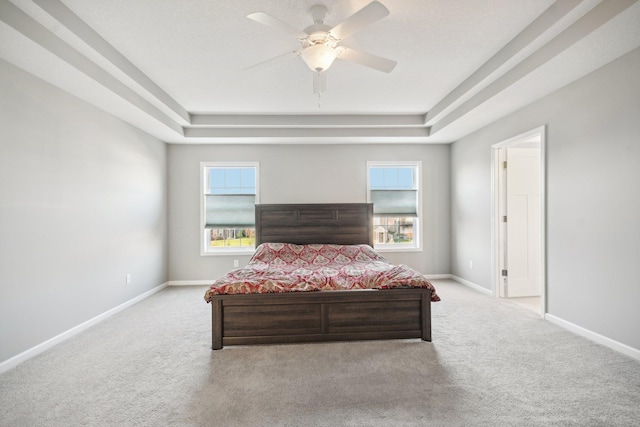 bedroom featuring light carpet, multiple windows, and ceiling fan