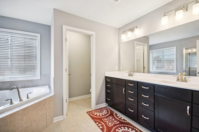 bathroom with toilet, vanity, a relaxing tiled tub, and tile patterned floors