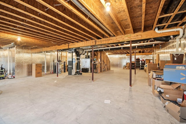 basement with water heater and heating unit