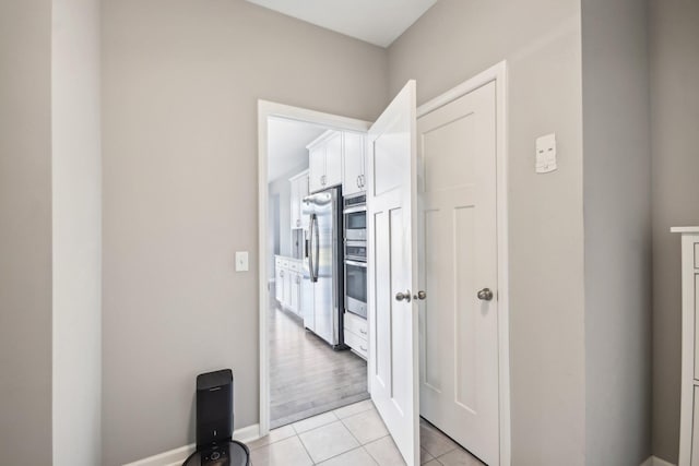 corridor with light tile patterned floors