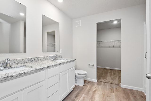 bathroom featuring hardwood / wood-style floors, vanity, and toilet