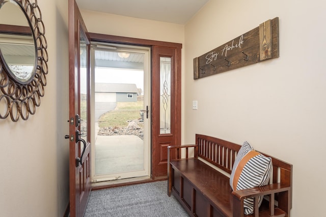 doorway to outside featuring carpet floors