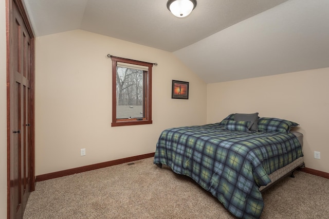 carpeted bedroom featuring vaulted ceiling