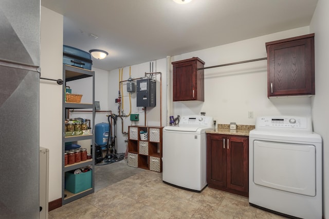 washroom featuring washer and clothes dryer and cabinets