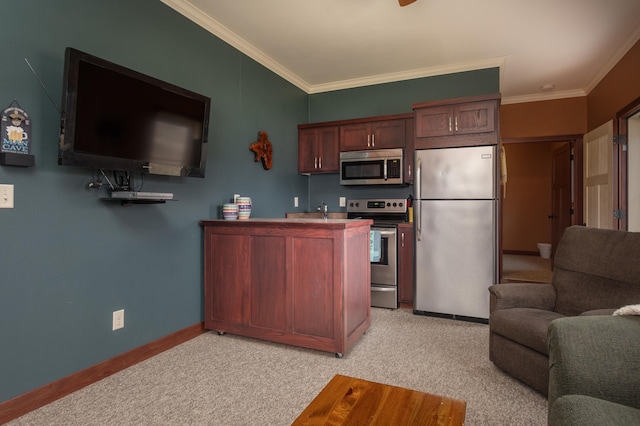 kitchen featuring ornamental molding, stainless steel appliances, and light carpet