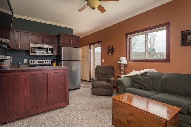 living room with ceiling fan, ornamental molding, and light carpet