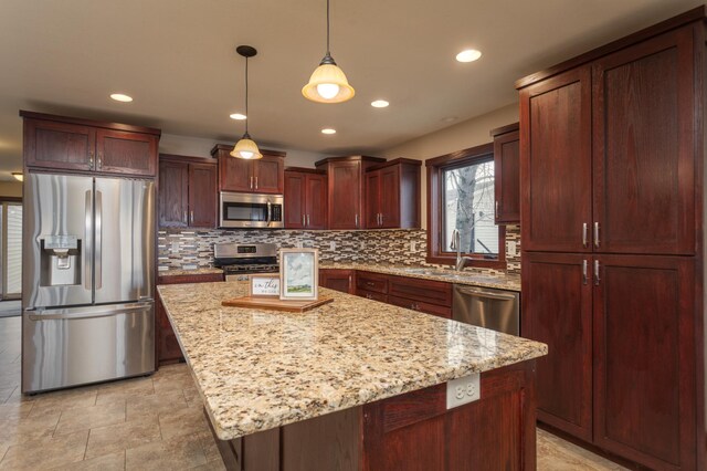 24539 Twilight Ln, Pelican Rapids, MN 56572 - kitchen featuring stainless steel appliances, a sink, tasteful backsplash, decorative light fixtures, and a kitchen island