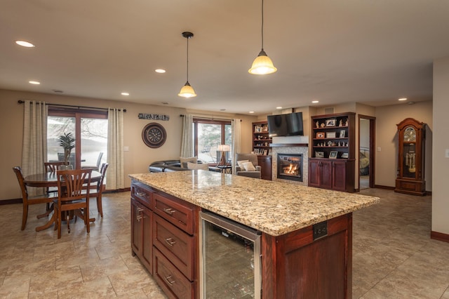 24539 Twilight Ln, Pelican Rapids, MN 56572 - kitchen featuring beverage cooler, baseboards, recessed lighting, decorative light fixtures, and a glass covered fireplace
