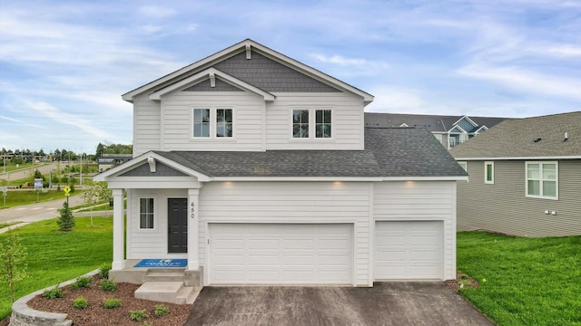 view of front of home with a garage and a front yard