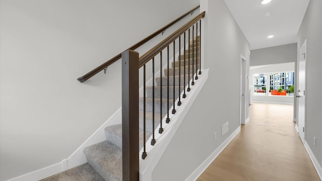 staircase featuring hardwood / wood-style floors