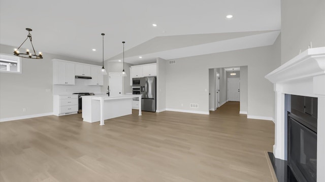 unfurnished living room with light hardwood / wood-style flooring and vaulted ceiling