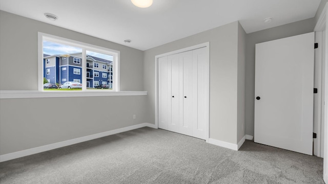 unfurnished bedroom with a closet and carpet floors