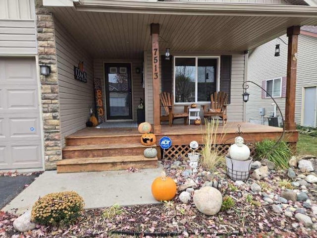 property entrance featuring a porch and a garage