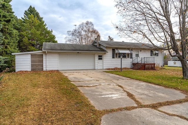 ranch-style home featuring a garage and a front yard