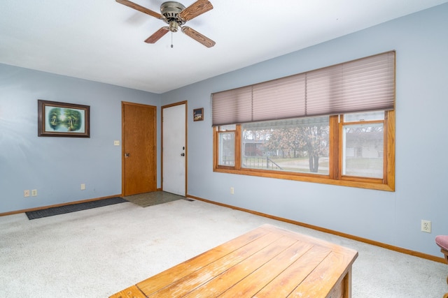 unfurnished bedroom featuring carpet and ceiling fan