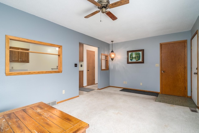 carpeted empty room with ceiling fan