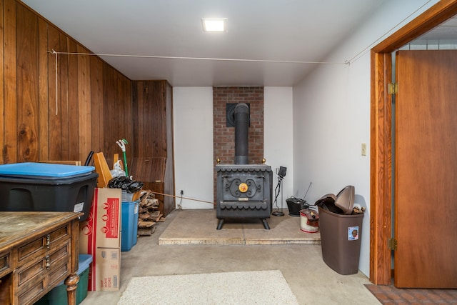 interior space with wooden walls and a wood stove