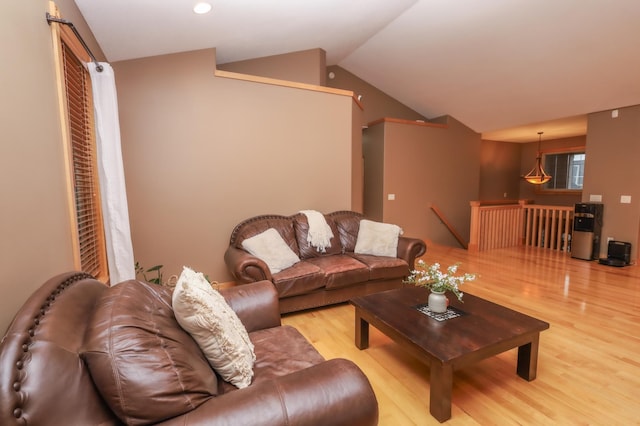 living room featuring light wood-type flooring and vaulted ceiling