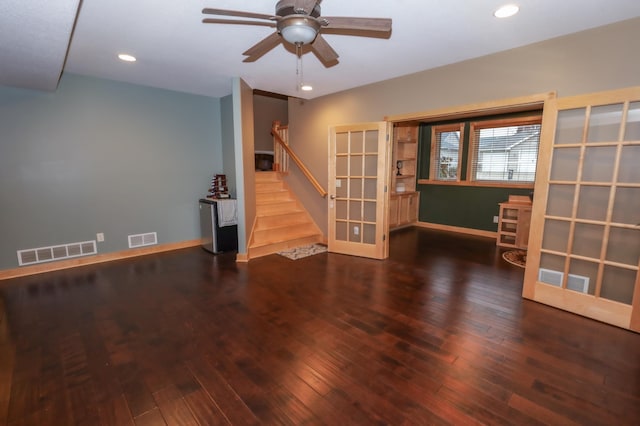 spare room featuring dark hardwood / wood-style floors, ceiling fan, and french doors