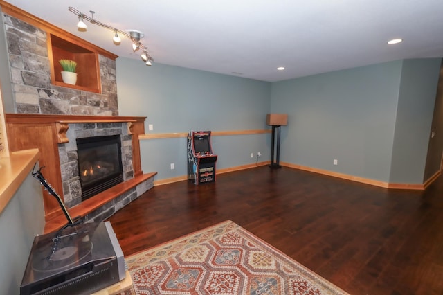 living room featuring a fireplace and dark wood-type flooring