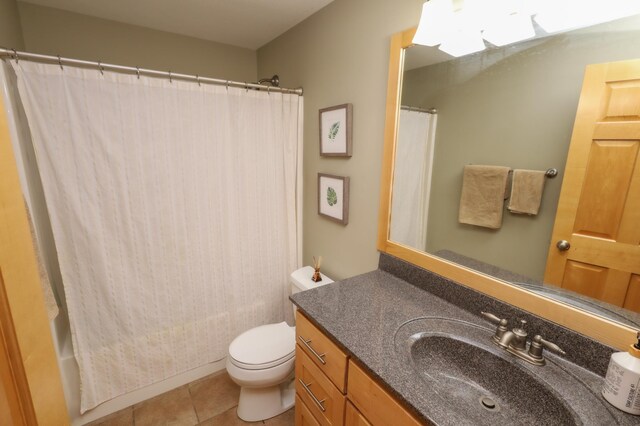 bathroom featuring tile patterned flooring, vanity, and toilet