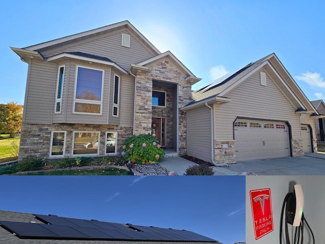 view of front of property with a garage and solar panels